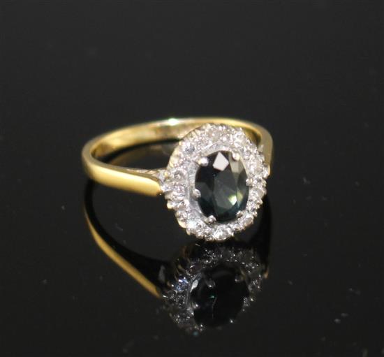 An 18ct and Plat, sapphire and illusion set diamond oval cluster ring, size M, gross weight 3.5 grams,